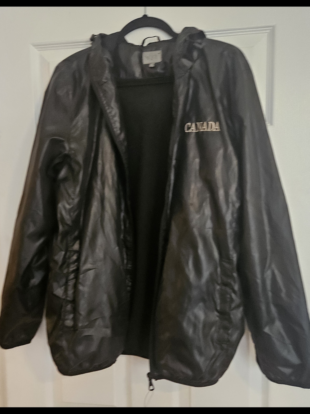 NWOT. Black Canada Hooded Wind breaker Lightweight Jacket. Size XL.